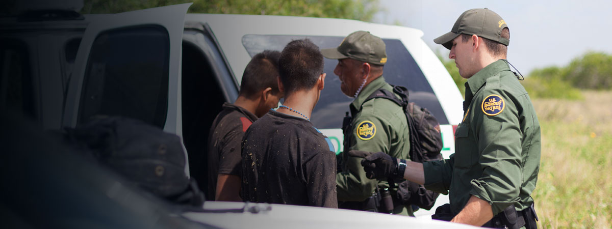United States Border Patrol agents arrest immigrants crossing border illegally.