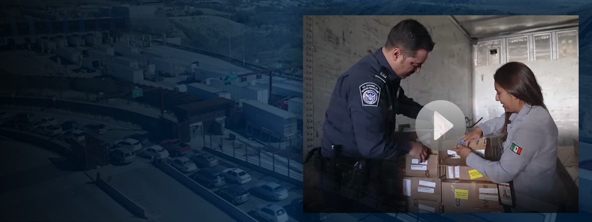 CBP Officers talking in front of cargo at a port of entry