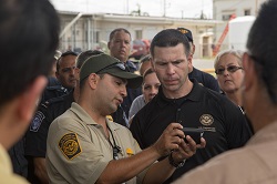 Acting Commissioner views an agent's phone