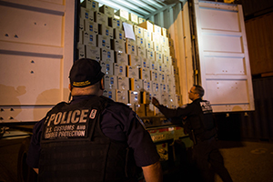 CBP officers conduct an on-the-spot physical inspection of a shipping container at the port of Long Beach in California