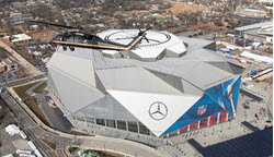 Working as the eyes in the sky, an AMO Black Hawk makes a pass over Atlanta’s Mercedes-Benz Stadium.