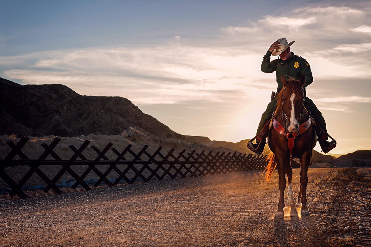 Border Patrol agent on horseback patrolling the border
