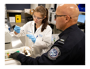 Photo of CBP laboratory scientist working with a CBP officer to identify suspect substances