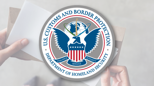 Person opening a letter with the CBP Seal in the foreground.