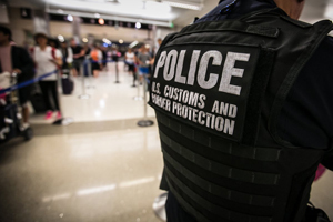File photo of a Customs and Border Protection officer observing travelers move through a CBP Port of Entry.