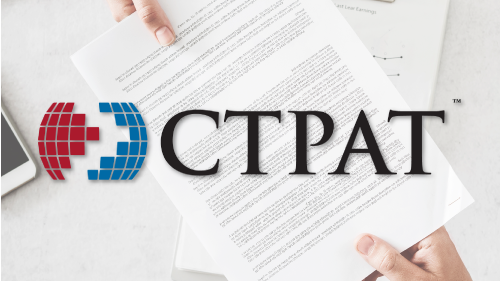 Person handing another person a letter with the CTPAT logo in the foreground.