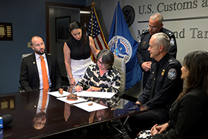 Ludmilla Ugalde (seated), Costa Rica Consul General, signs documents to accept her nation’s cultural artifacts from John Rico, CBP’s Asst. Director of Border Security for the Miami and Tampa Field Office during a repatriation ceremony in Miami on September 14, 2023.