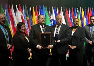 U.S. Border Patrol Agent Johnathan Morales holds the plaque naming him Officer of the Year with CBP Acting Commissioner Mark Morgan (right) during an awards ceremony at the International Association of Chiefs of Police Convention and Exposition in Chicago.  Photo by Department of Justice