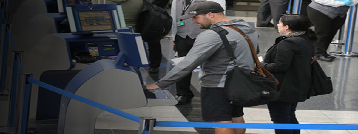 Travelers using Auomated Passport kiosks at Philadelphia International Airport.(SCOTT OLSON / Getty Images)