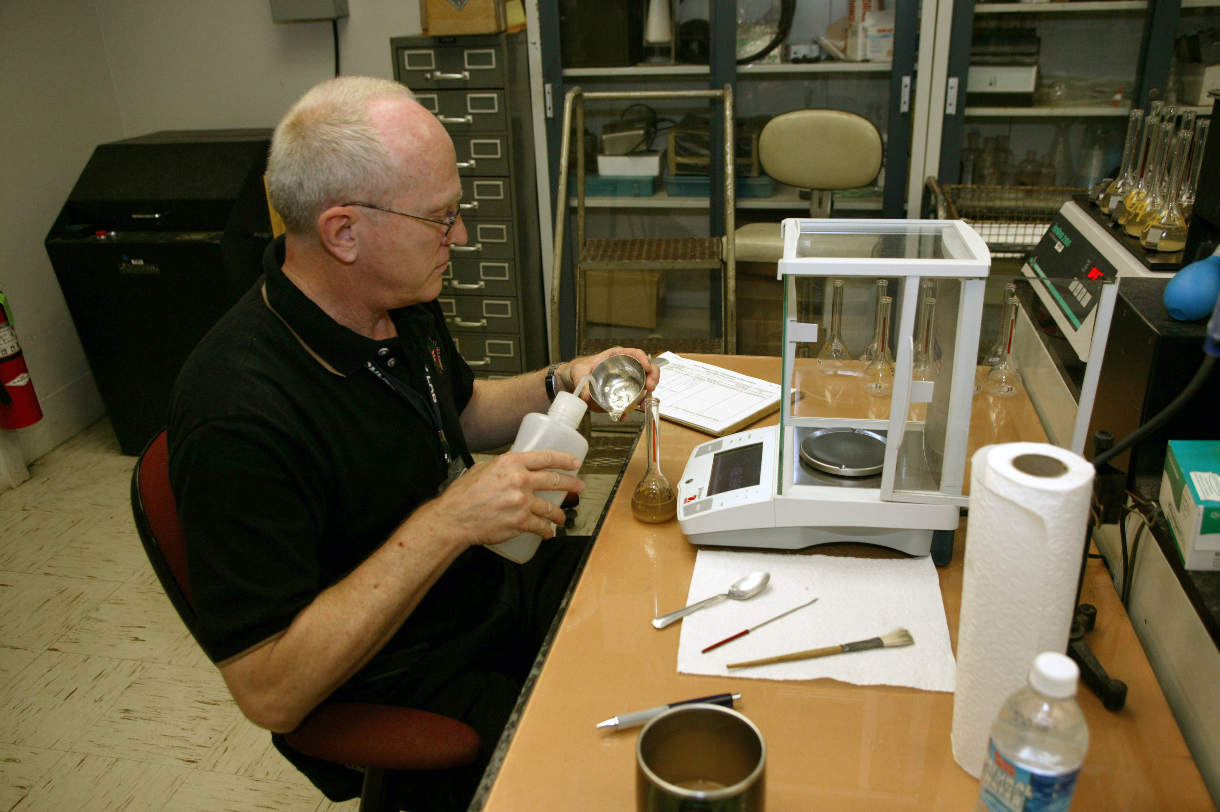 CBP Laboratory personnel prepare samples of metal to be analyzed.