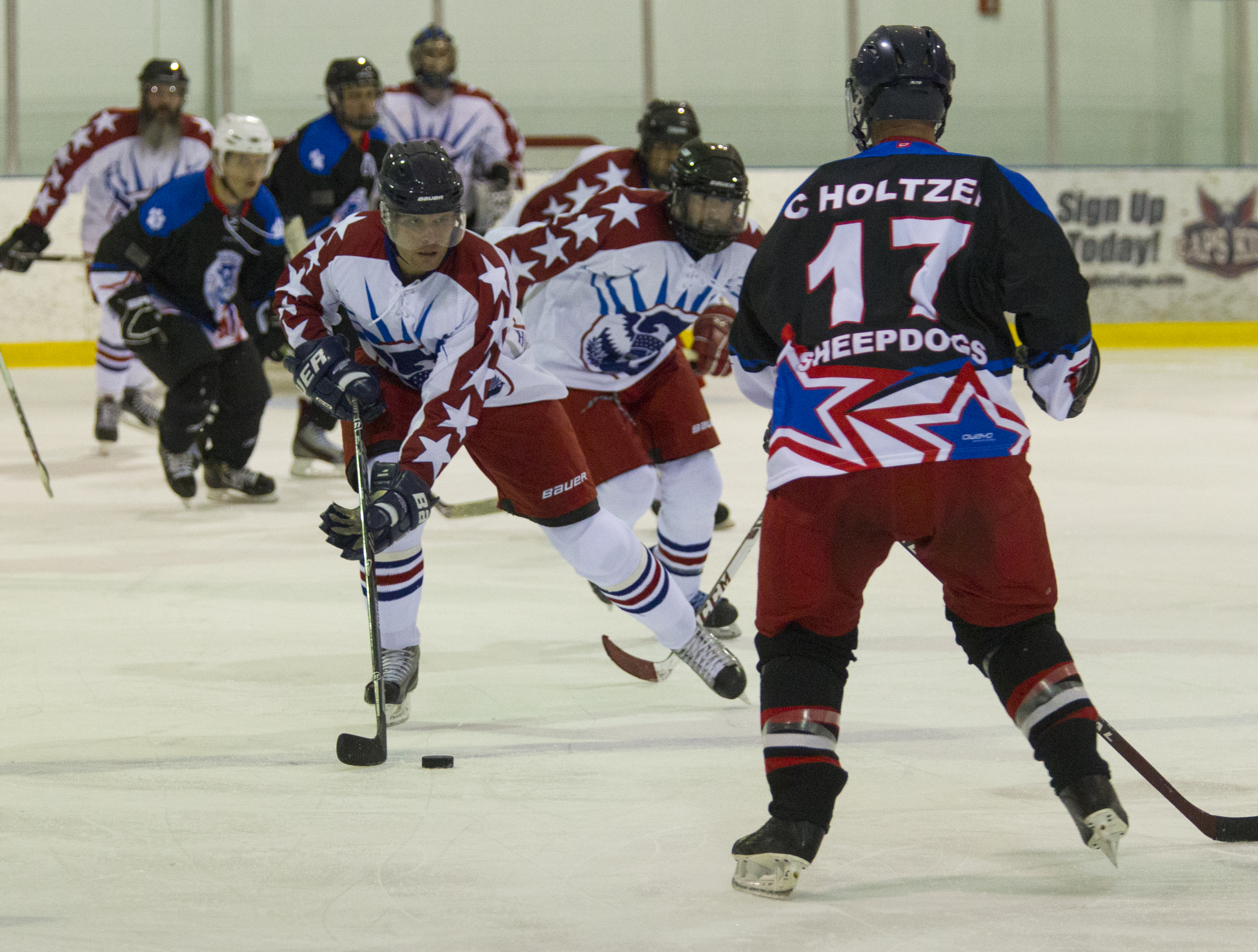 The CBP-ICE ice hockey team, in dark jerseys, defeated the Department of Homeland Security's team 4-2 in the first round at the 2015 World Police & Fire Games. Ice hockey matches were played throughout the tournament’s seven days. Photo by James Tourtellotte