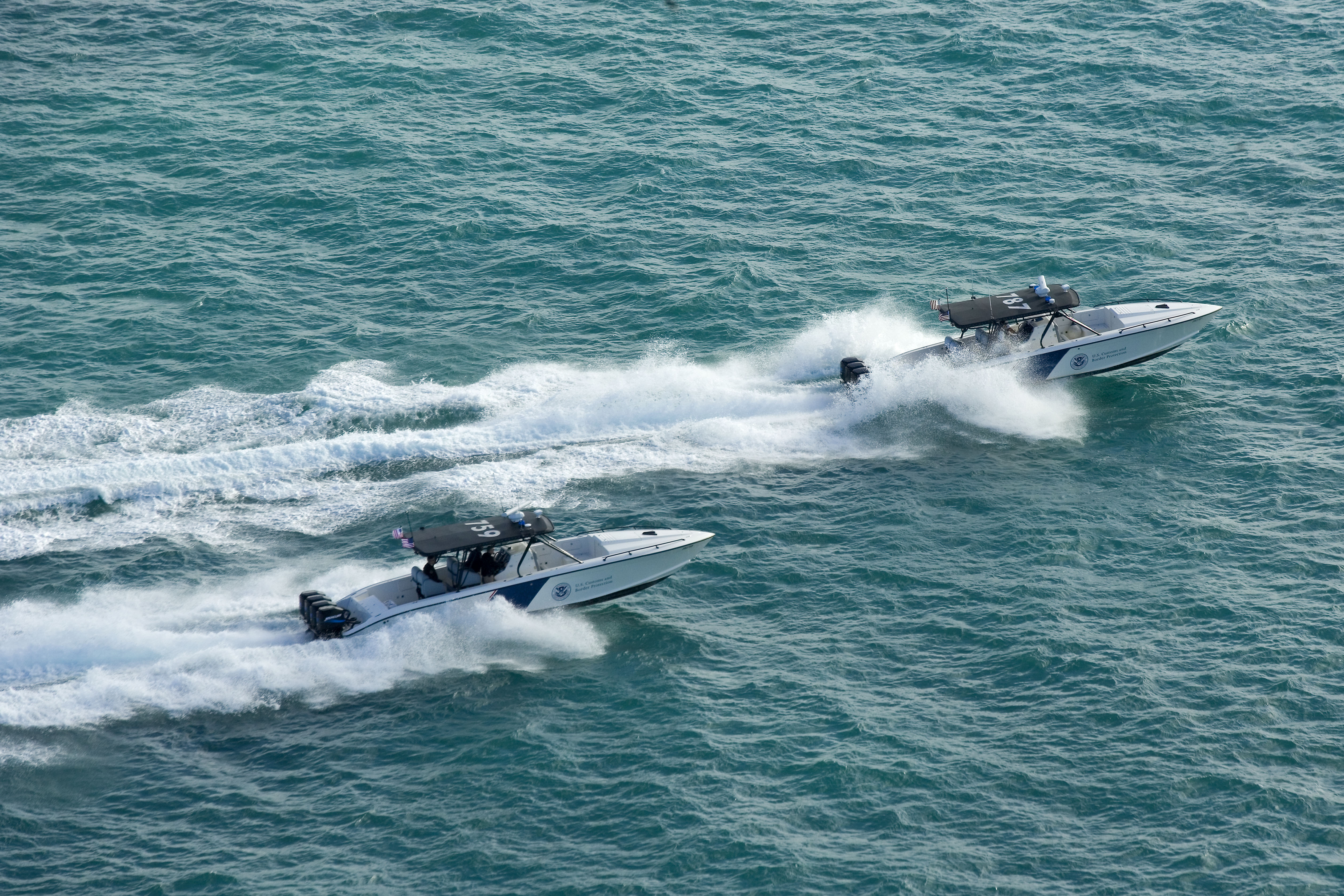 Two CBP marine interceptor vessels patrol the waters off of the U.S.