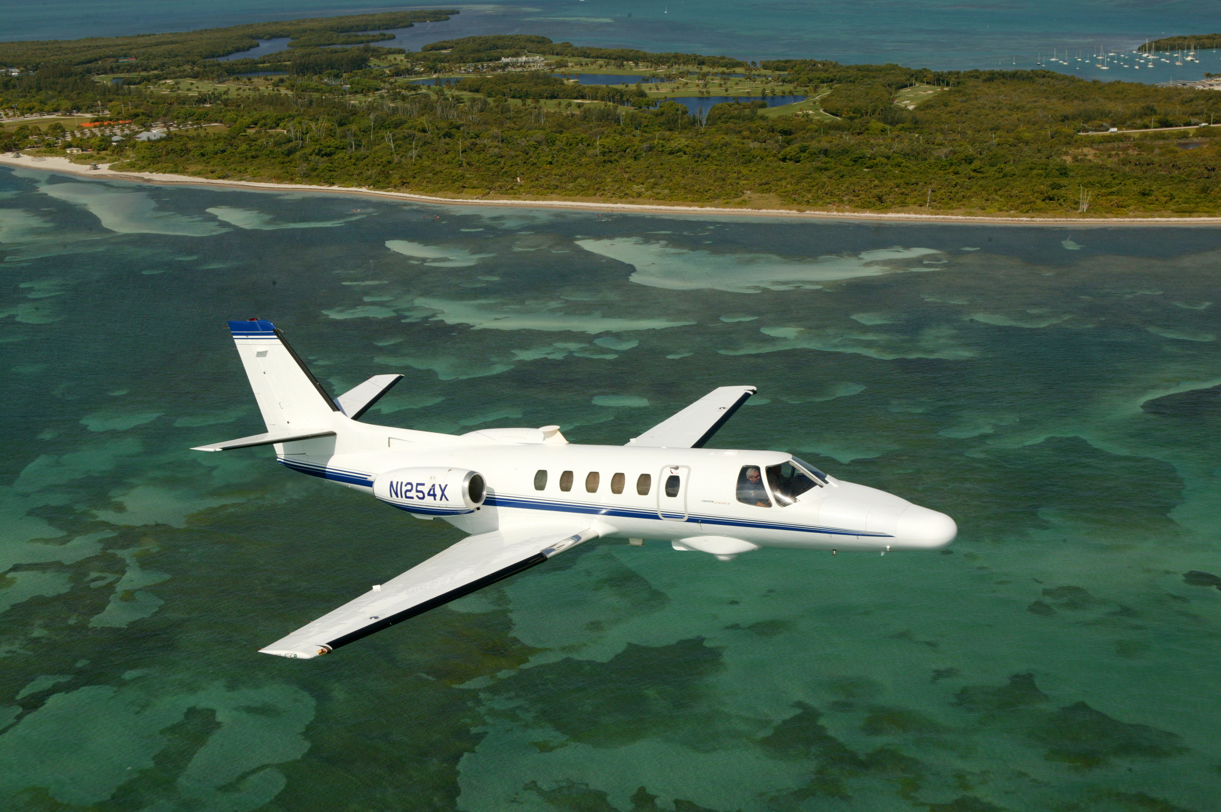 A CBP Air unit Citation Jet patrols the waters off of a National Park of the United States.