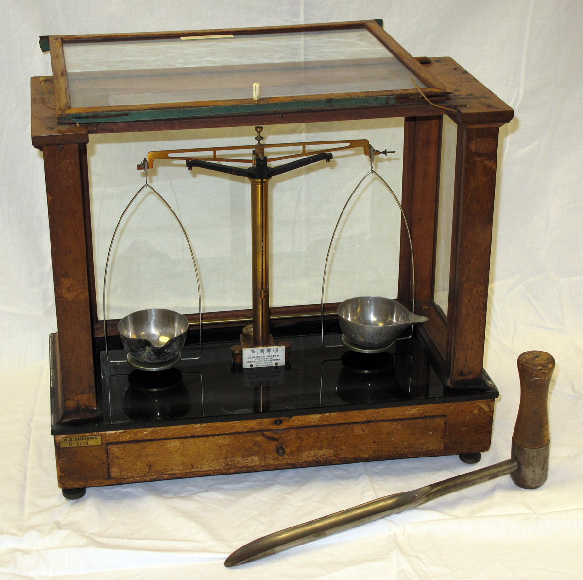 This sugar balance and trier (scoop) were used by U.S. Customs Service in preparing sugar for testing. They were manufactured to precise specifications to insure equality in sampling across all of Customs.