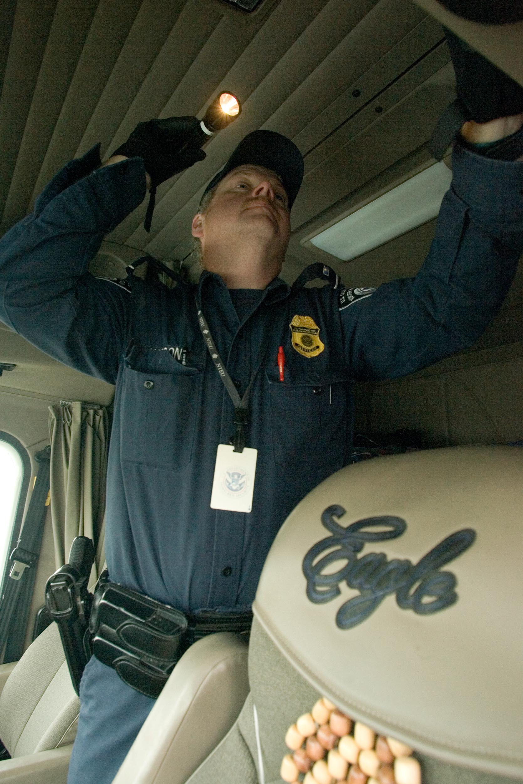 CBP officer inspects the cab of a truck at the northern border port of Sweetgrass Montana.