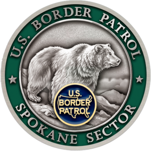 spokane challenge coin background is green and there is a grey bear on the front.