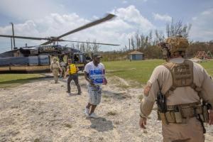 An AMO UH-60 crew delivers supplies to people in the Bahamas during Hurricane Dorian recovery missions.