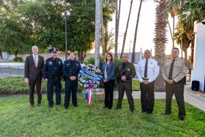 Leadership from federal, state and local law enforcement partners pose with Port Director Albert Flores and the 9/11 wreath during the 21st annual remembrance ceremony to honor 9/11 attack victims.