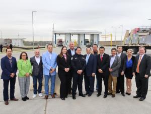 Leadership officials from CBP, GSA, City of Laredo, U.S. House of Representatives, TxDOT and the international trade sector pose in front of the four new FAST lanes dedicated at World Trade Bridge in Laredo, Texas.