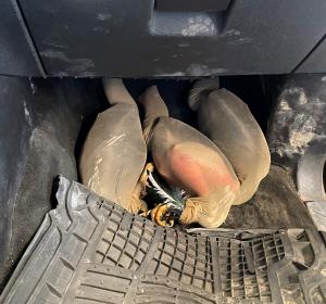 Three live roosters stuffed in stockings hidden under floormats discovered by CBP agriculture specialists at Laredo Port of Entry.