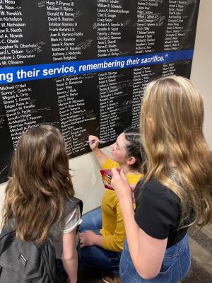 Rudd children write on a commemorative banner at the National Police Week host hotel