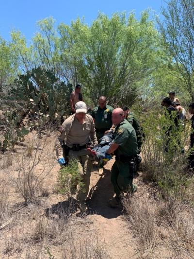 A Laredo Air Branch AMO agent works with Border Patrol partners to render medical aid to a migrant in distress on June 4, 2020.