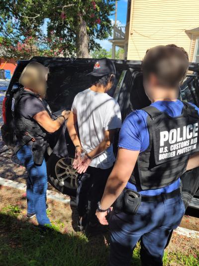 Two task force officers arresting subject