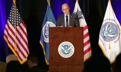CBP Commissioner Chris Magnus stands at a podium and welcomes attendees to the CBP 2022 Trade Facilitation and Cargo Security Summit.