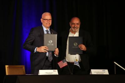 CBP Commissioner Chris Magnus, left, and Director General for the Uruguay National Customs Directorate Jaime Borgiani proudly hold signed mutual recognition arrangement documents.