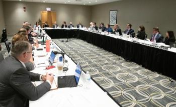 Members of the Commercial Customs Operations Advisory Committee sit around a large U-shaped table. CBP Deputy Commissioner Troy Miller sit at the head of the table. who co-hosted the Sept. 14 meeting.