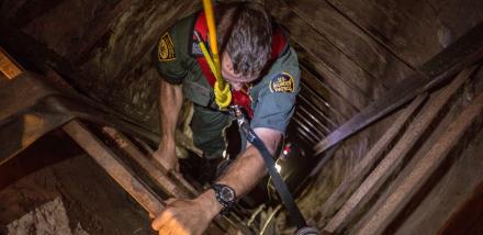 Photo of Border Patrol agent descending into tunnel