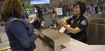 A CBP officer processes an international passenger at Boston Logan International Airport. 