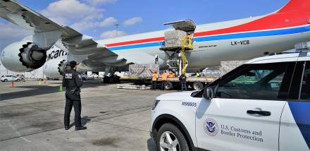 CBP Officer watches air cargo unload
