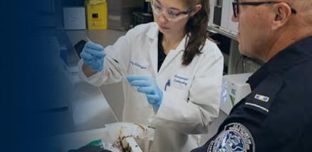 CBP scientist and OFO officer in a lab