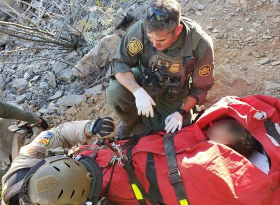 Arizona Department of Public Safety officer, above left, assists a Border Patrol agent with a medical extraction in Arizona 
