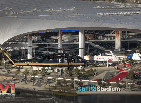 Two Air and Marine Operations helicopters fly over the Super Bowl stadium in 2022.