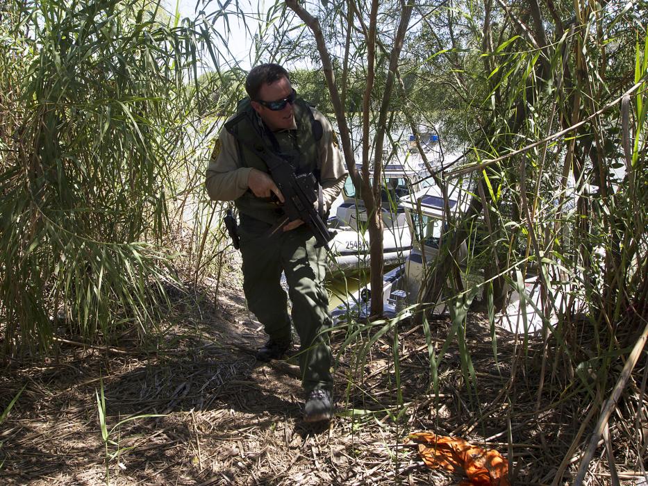 Photo of a Border Patrol agent patroling on shore.