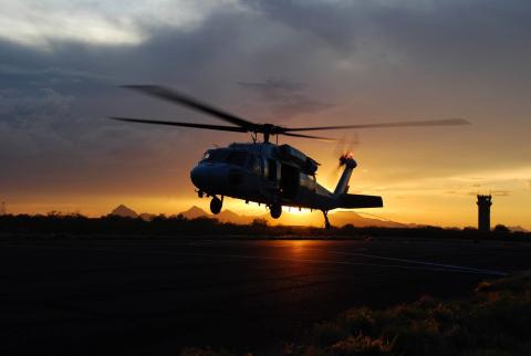 An Air and Marine Operations UH-60 crew takes off during a desert sunset near Tucson, Arizona