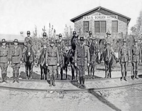 U.S. Immigration Service Border Patrol inspectors in formation in front of the Border Patrol's first training facility in Camp Chigas.