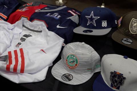 Various counterfeit items, like hats and jerseys are on display