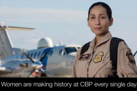 A female CBP Air and Marine Operations Pilot stands in front of an aircraft