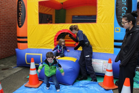 Kids playing in a bounce house.