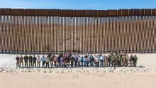 USBP Agents, local media and partners stand in front of border wall in El Centro Sector