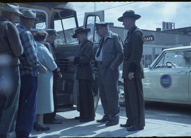 Border Patrol agents check bus passengers.