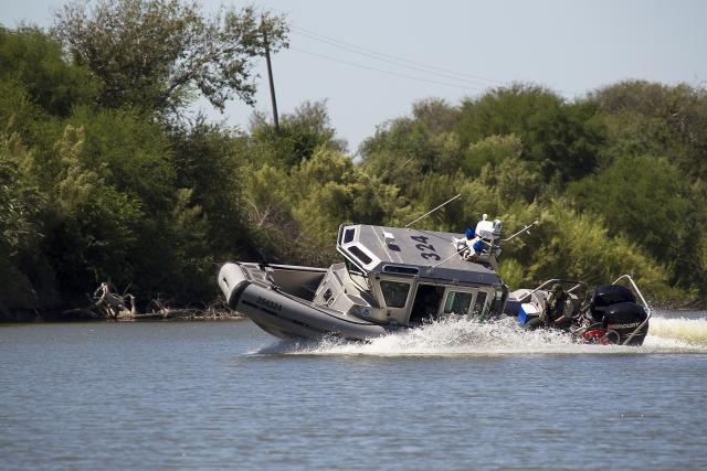 Border Patrol riverine agents maneuver a SAFE boat on the Rio Grande.