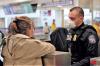 An officer with a traveler at a Preclearance facility