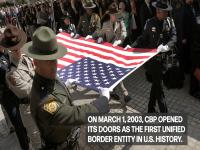 CBP Officers and Agents hold the US Flag flat