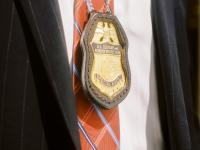 Badge hanging on the neck of an OPR Special Agent