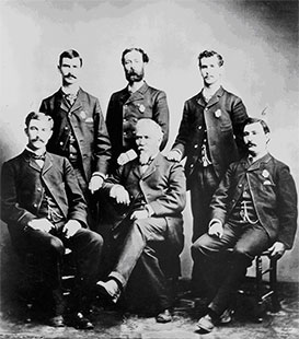 Circa 1888: Col. Abner Tibbetts (center) poses with 5 of the 25 Customs Mounted Inspectors assigned to the Customs Collection Di
