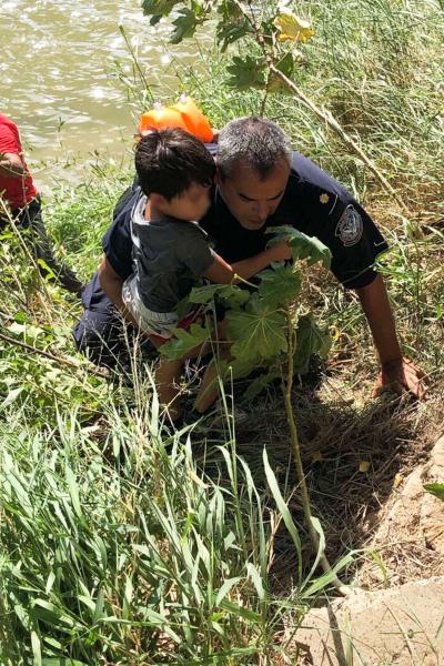 CBP officer holding child